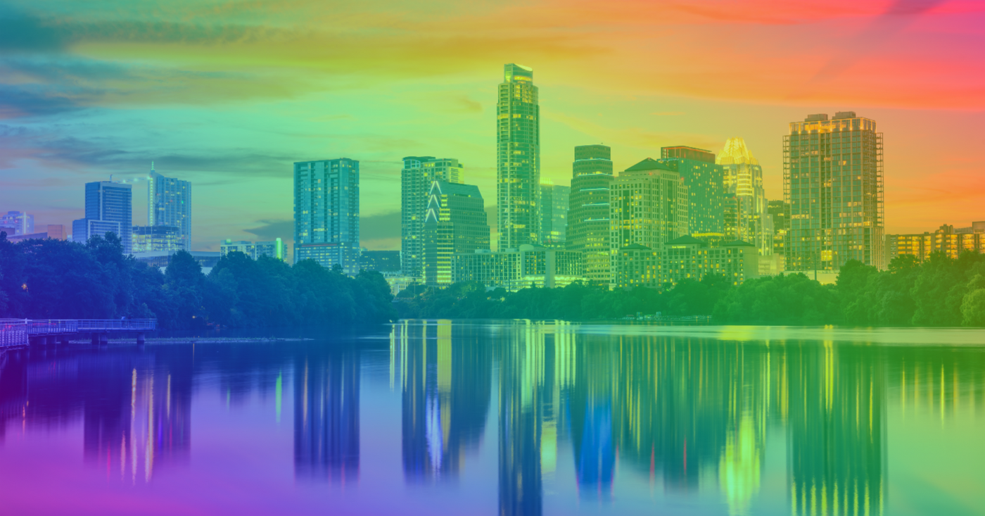 picture of downtown austin with lady bird lake, rainbow hue over the whole picture